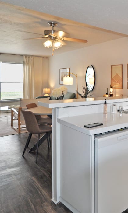 A modern kitchen with white appliances and a dining table.