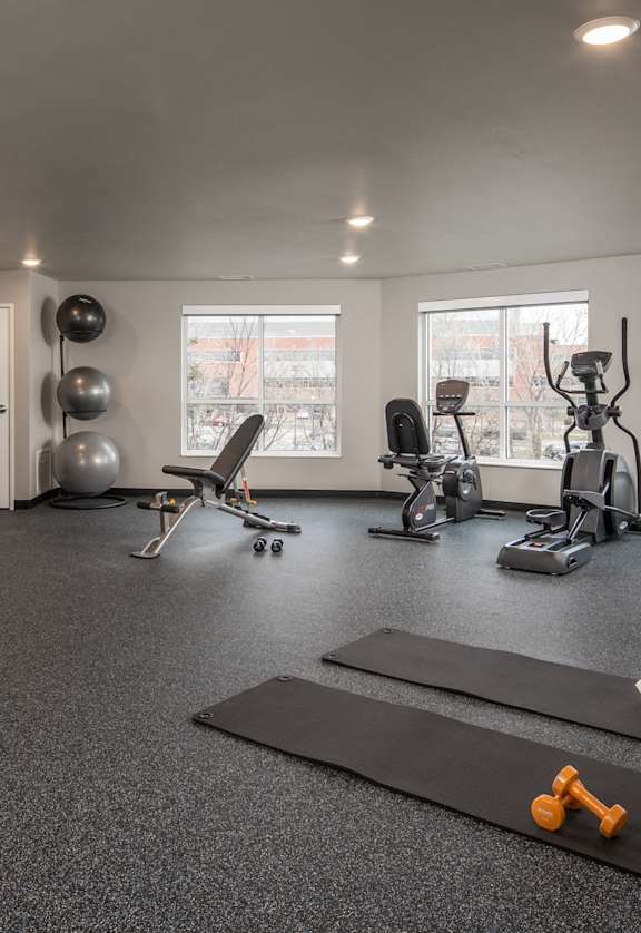A spacious home gym with a variety of exercise equipment.