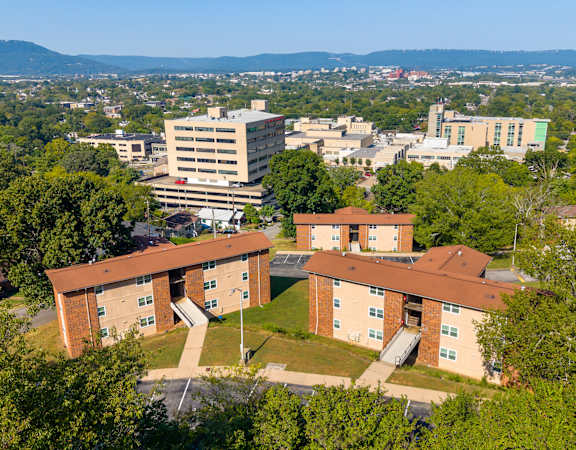 A large building complex with a parking lot in front.