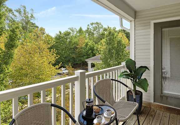 a patio with a table and chairs on a porch