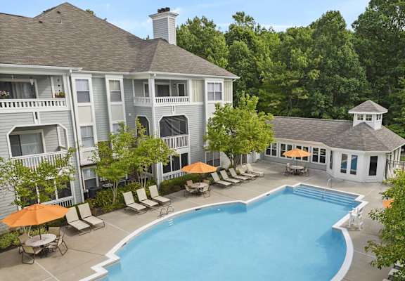 a view of the pool and the backyard of a house with a swimming pool