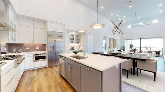 a large kitchen with an island and a dining table