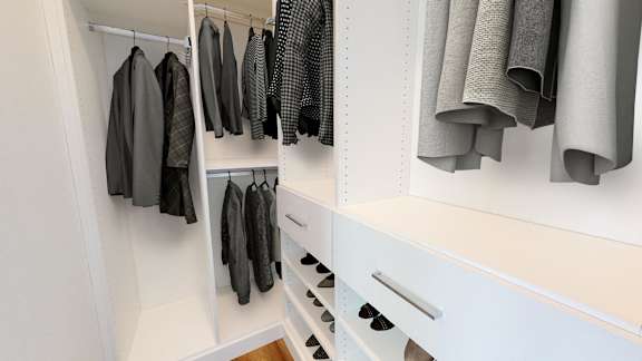 a walk in closet with white cabinets and drawers