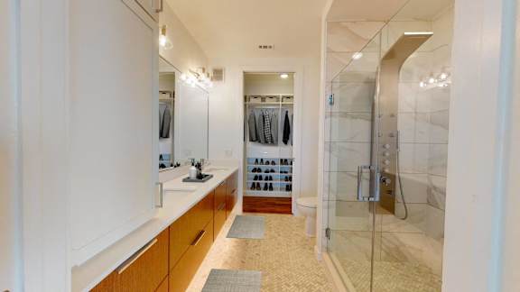 a bathroom with a shower and a sink and a mirror