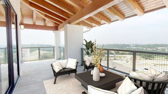 a living room with a table and chairs on a balcony