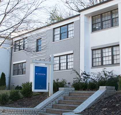 A white building with a blue door and windows.