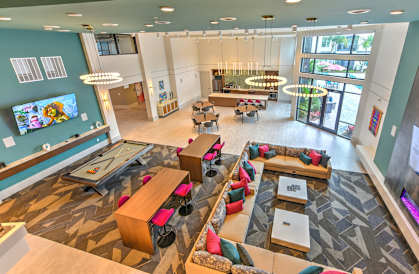 a large lobby with couches and tables and a tv at Pinnacle Apartments , Florida, 32256