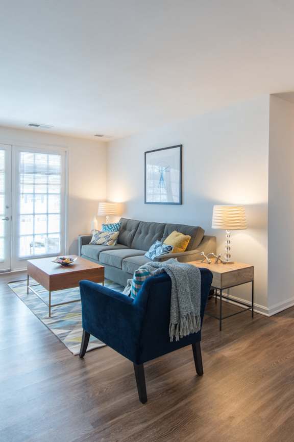 Four chairs are arranged in a sunny room.