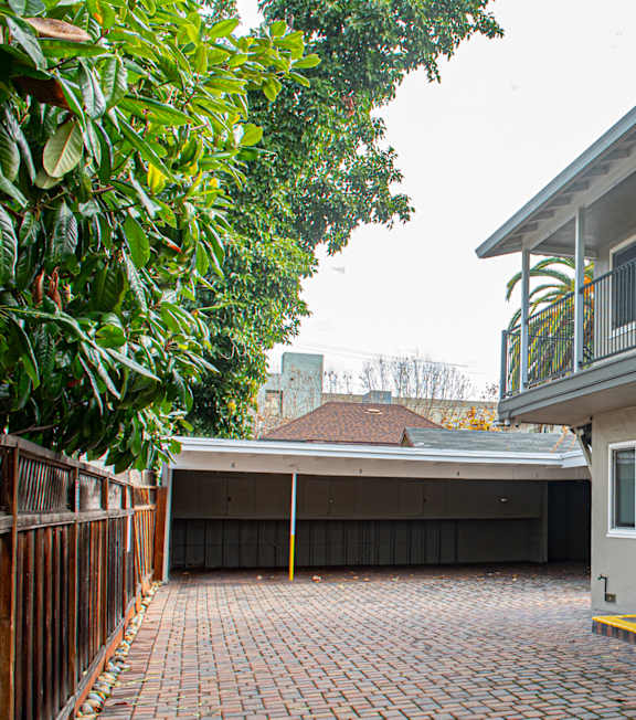 A small pool in a courtyard surrounded by apartment buildings.