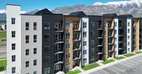 an apartment building with mountains in the background