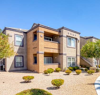 A sunny day at a residential complex with a clear blue sky.