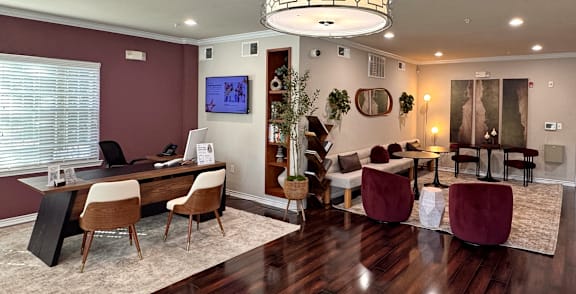 A modern living room with a dark wood floor and a large chandelier.
