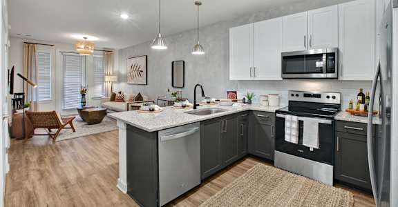 A modern kitchen with a large island and stainless steel appliances.