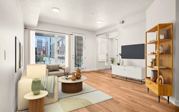 A living room with a white sofa, a wooden coffee table, and a flat screen TV.
