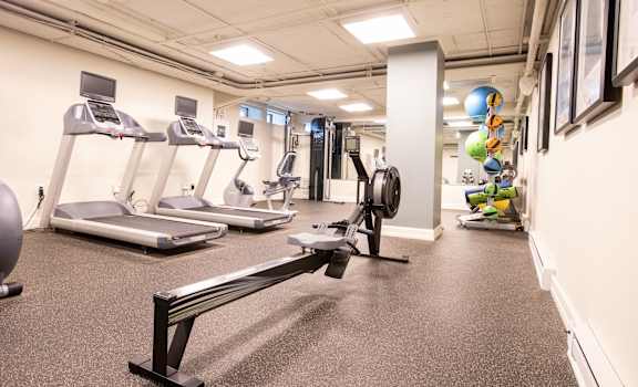 a gym with treadmills and other exercise equipment in a building