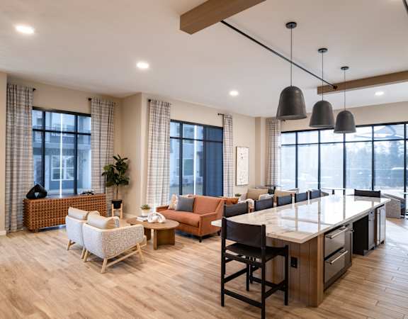 A modern kitchen with a dining table and chairs.at The William, Chantilly