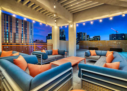 Rooftop Patio with Blue Couches at The Rey Downtown Apartments, Phoenix, Arizona