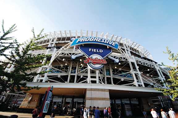 A large stadium with a blue and white sign that says "Progressive Field".