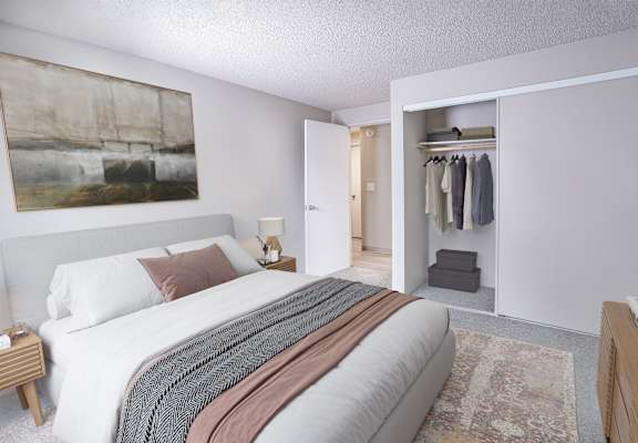 a bedroom with a bed and a closet