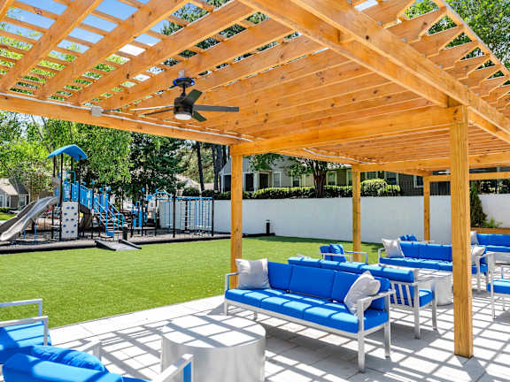 Patio with fan and couches at Station Heights Apartments in Alpharetta, GA, 30022