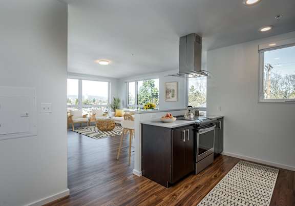 A kitchen with a black stove top oven and a black refrigerator.