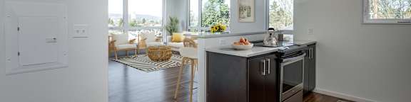A kitchen with a black stove top oven and a black refrigerator.