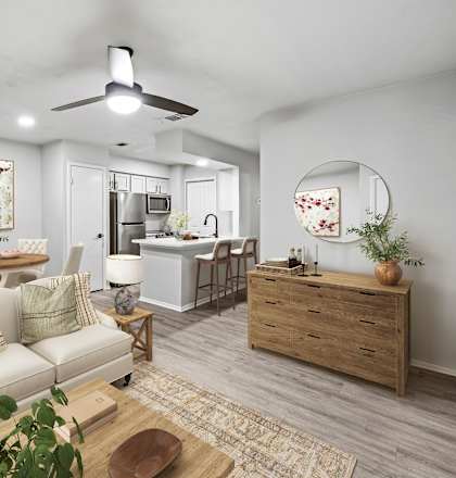our apartments offer a living room with a couch a coffee table and a dining table  at Carmel at Deerfield, San Antonio