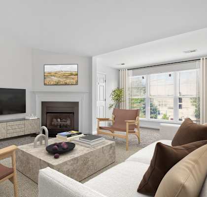 A living room with a fireplace, a television, and a painting on the wall.