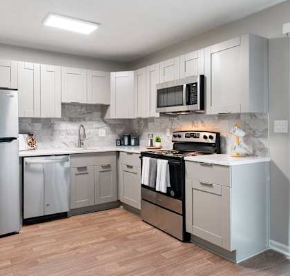 a kitchen with stainless steel appliances and white cabinets