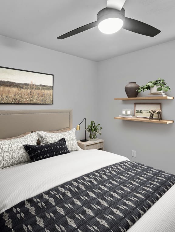 a bedroom with a ceiling fan and a window with a blind  at Carmel at Deerfield, San Antonio, Texas
