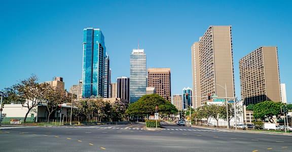 an empty city street with skyscrapers in the background