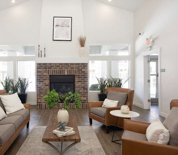 a living room with white walls and a brick fireplace at The Alloy at Geneva, Vineyard, 84058