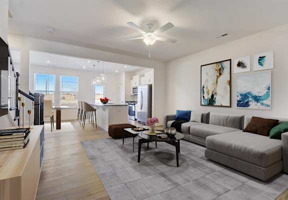A modern living room with a grey sofa and a coffee table.