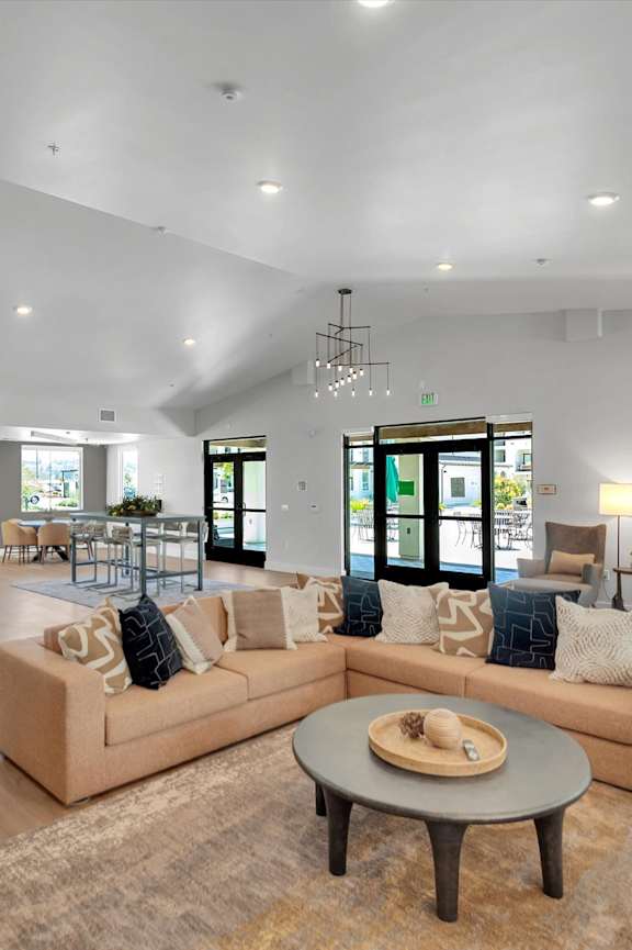 A living room with a brown sofa and a wooden coffee table.
