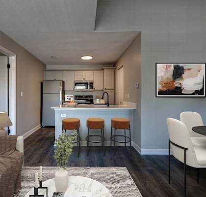 A modern kitchen with a bar stool and a white sofa.