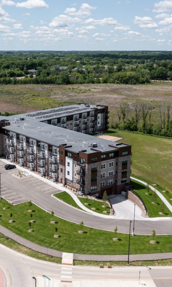 an aerial view of an apartment building next to a road