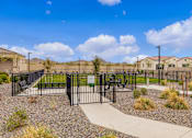 Thumbnail 3 of 5 - A black fence surrounds a gravel area with a concrete walkway and a green sign in the middle  at Avilla Canyon, Phoenix