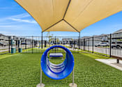 Thumbnail 6 of 8 - A playground with a blue slide and a yellow canopy.