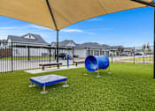 Thumbnail 7 of 8 - A playground with a blue slide and a yellow canopy.