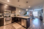 Thumbnail 25 of 78 - a kitchen with dark cabinets and stainless steel appliances  at EdgeWater at City Center, Lenexa, KS, 66219