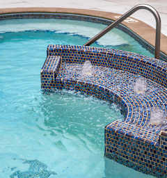 Courtyard pool and spa with seating area at The Flats at West End Apartments, St. Louis Park, 55416