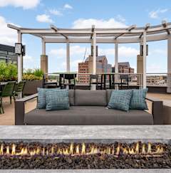 Rooftop patio with pergola and city skyline views at The Flats at West End Apartments, St. Louis Park, Minnesota