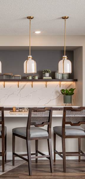 A dining table with chairs and a candle holder on top of it.