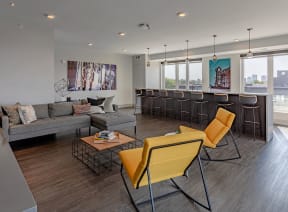 a living room with couches and chairs and a bar