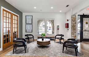 A room with a stone wall and a fireplace.