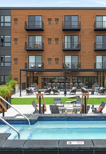 a swimming pool in front of an apartment building
