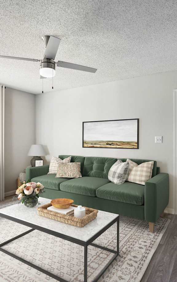 A living room with a green couch and a white chair.