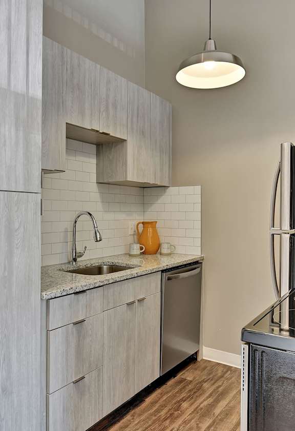 A modern kitchen with a stainless steel oven and a sink.