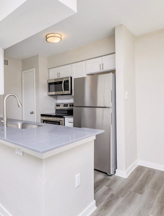 a large living room with a kitchen and a dining room