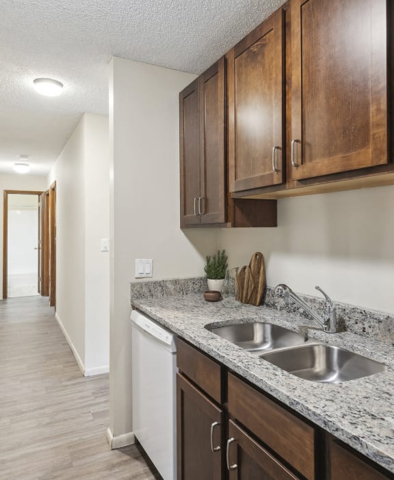 an empty kitchen with wood cabinets and a white refrigerator and sink at Silver Lake, New Brighton, 55112